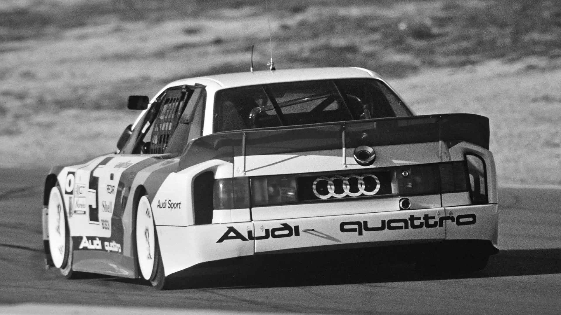 audi race car in the 1990s from behind on a race track