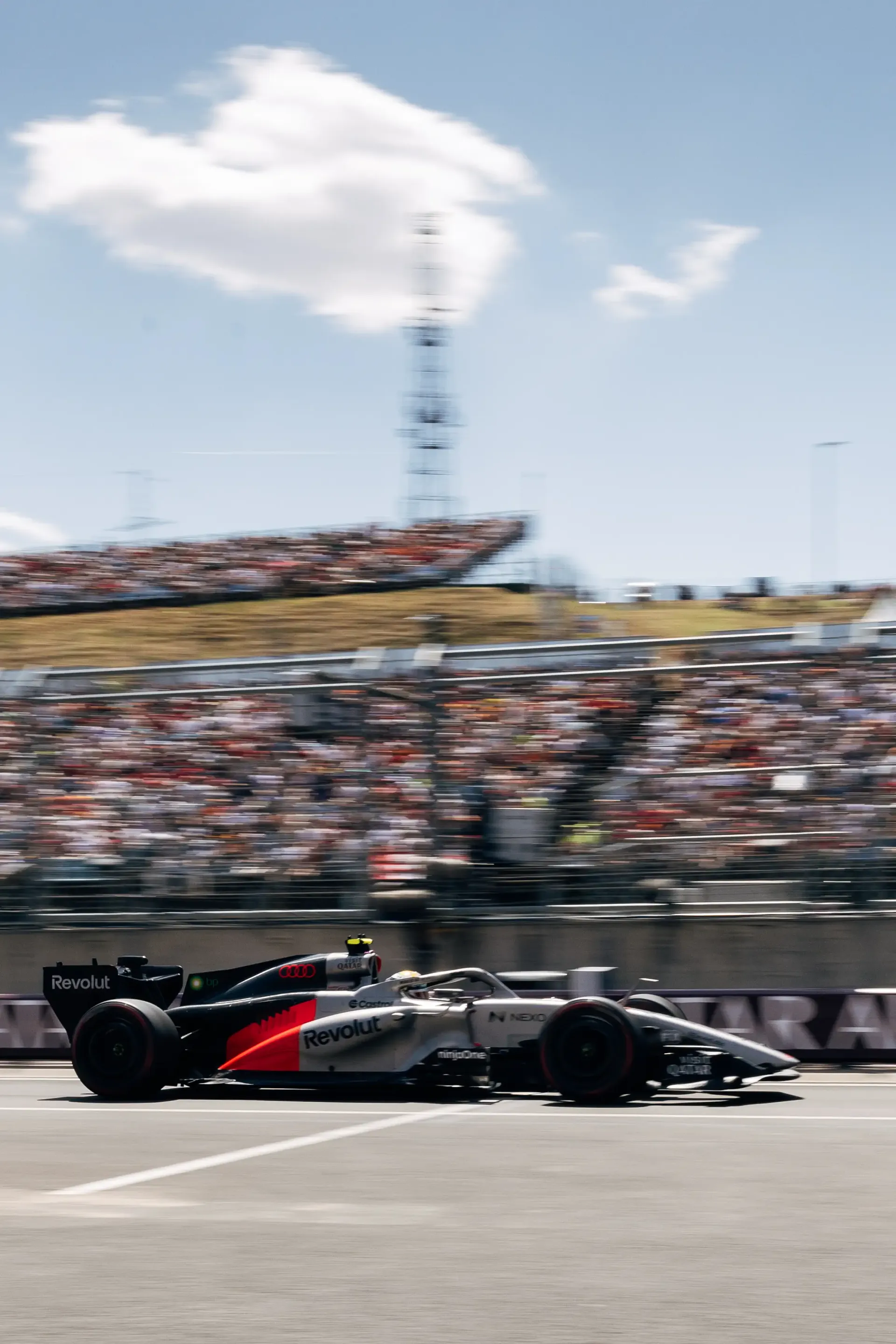 The Audi Revolut F1® Team Audi R26 on track during FP3 at the Hungaroring, with packed grandstands overlooking the circuit.