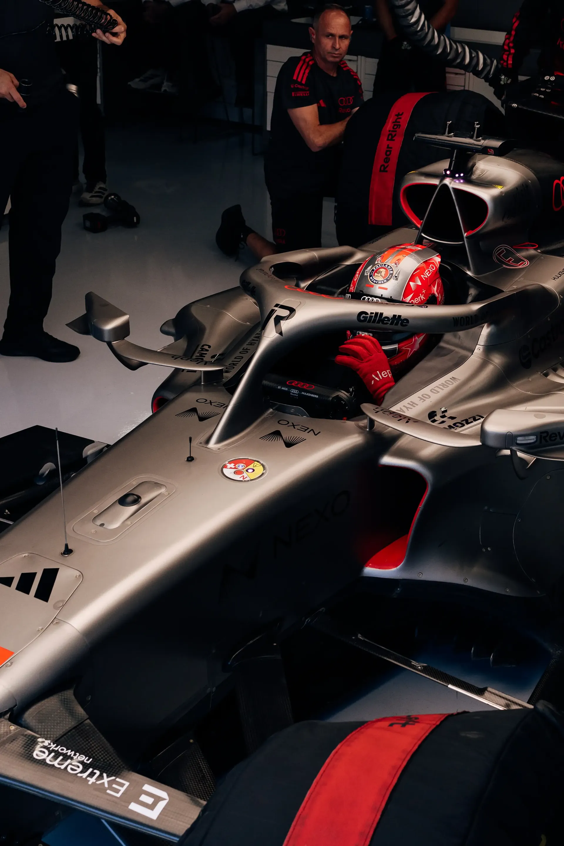 Audi Revolut F1® Team mechanics work on the Audi Revolut F1® Team Audi R26 inside the garage ahead of FP3.