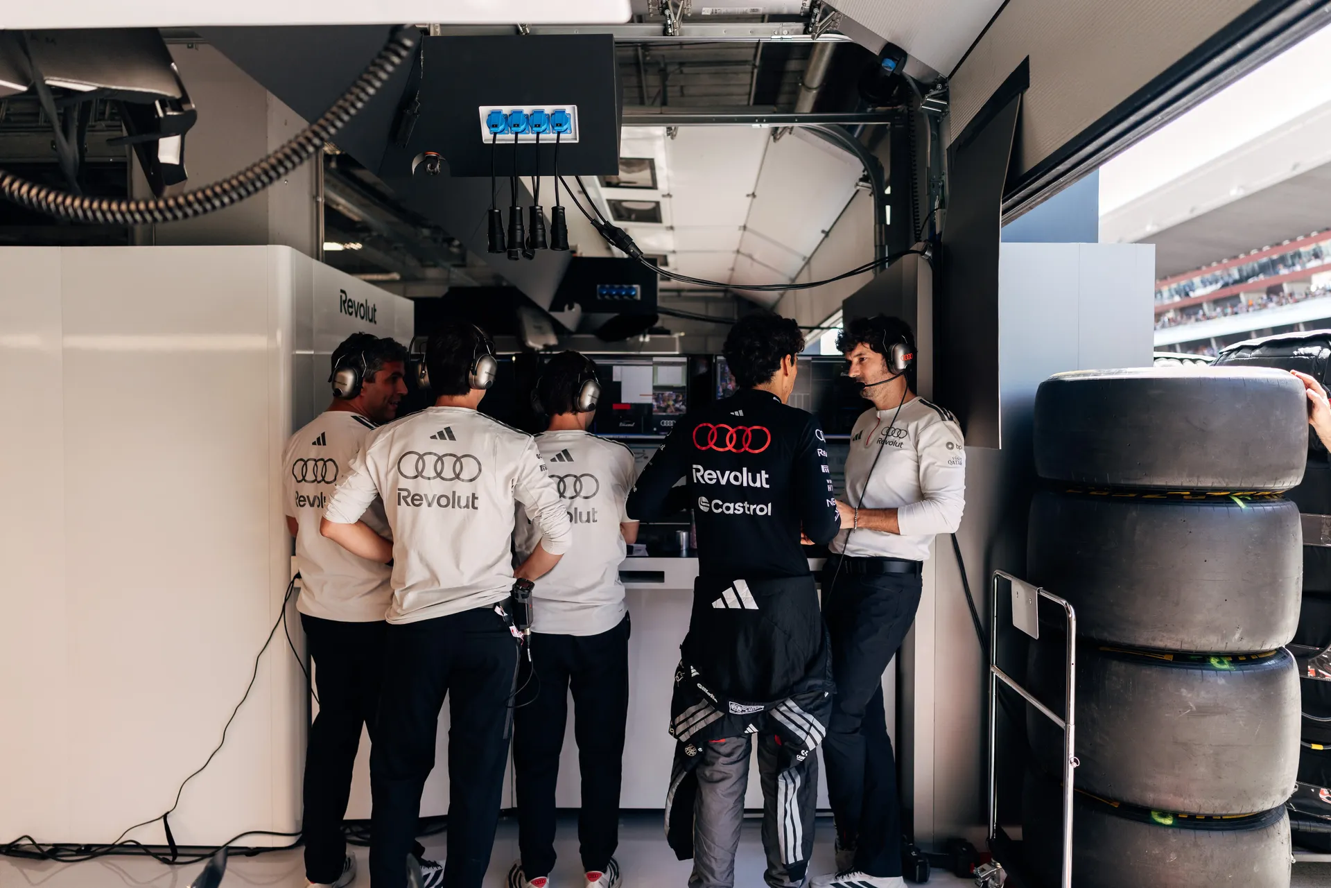 Audi Revolut F1® Team mechanics gather in the Audi Revolut F1® Team garage before FP3 at the Hungaroring.