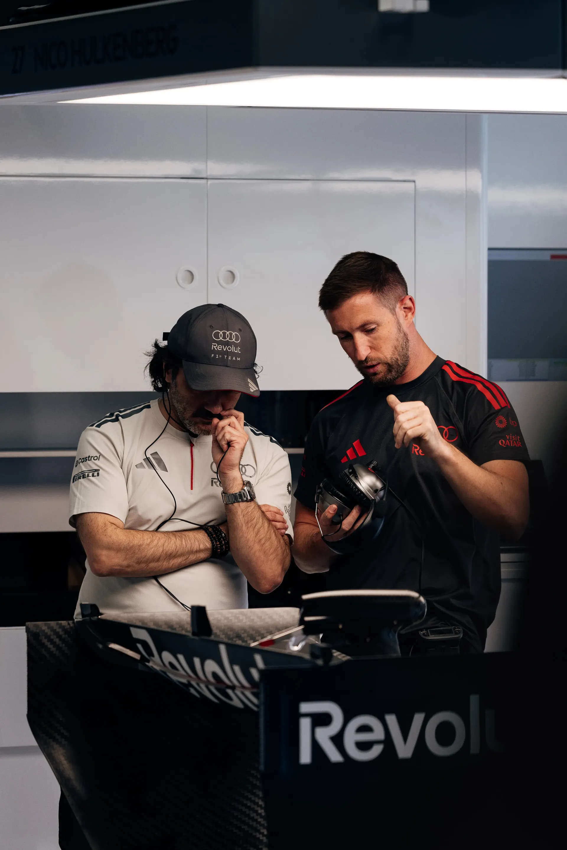 Audi Revolut F1® Team engineers review data together in the garage during FP1.