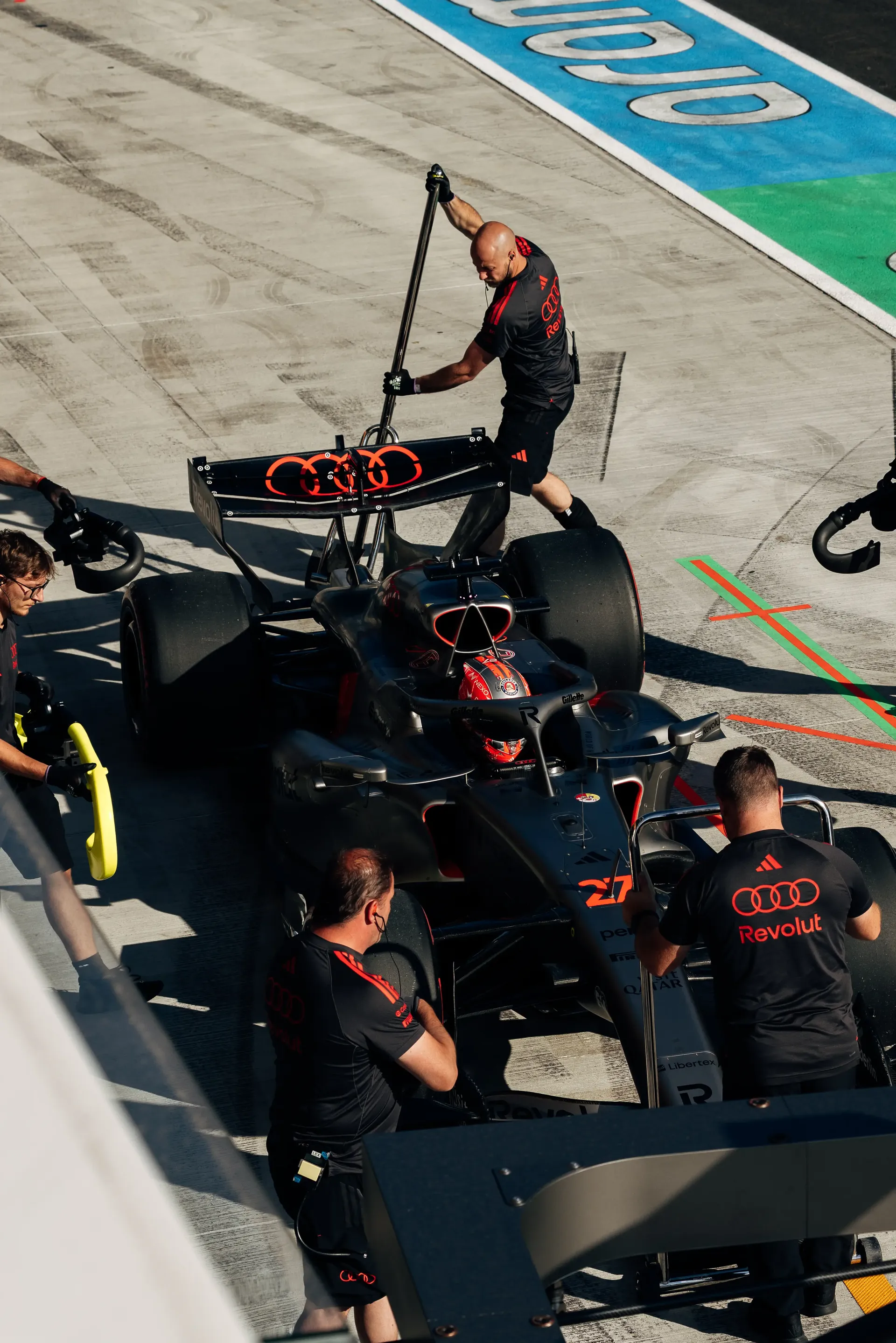 Overhead view of Audi Revolut F1® Team mechanics working on the Audi Revolut F1® Team car Audi R26 during FP2.