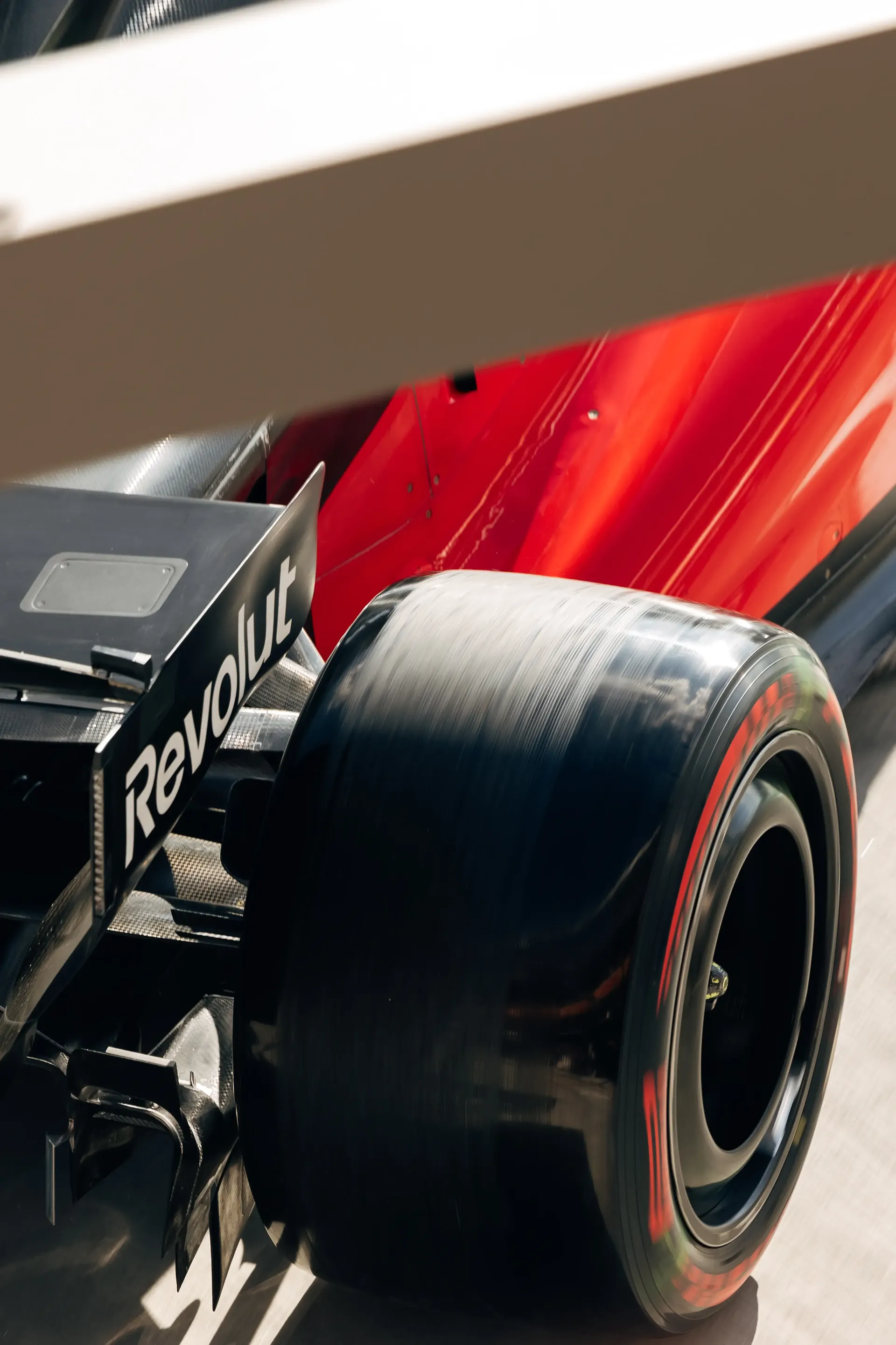 Close-up of the rear tyre and rear wing of the Audi Revolut F1® Team car Audi R26 inside the team garage.