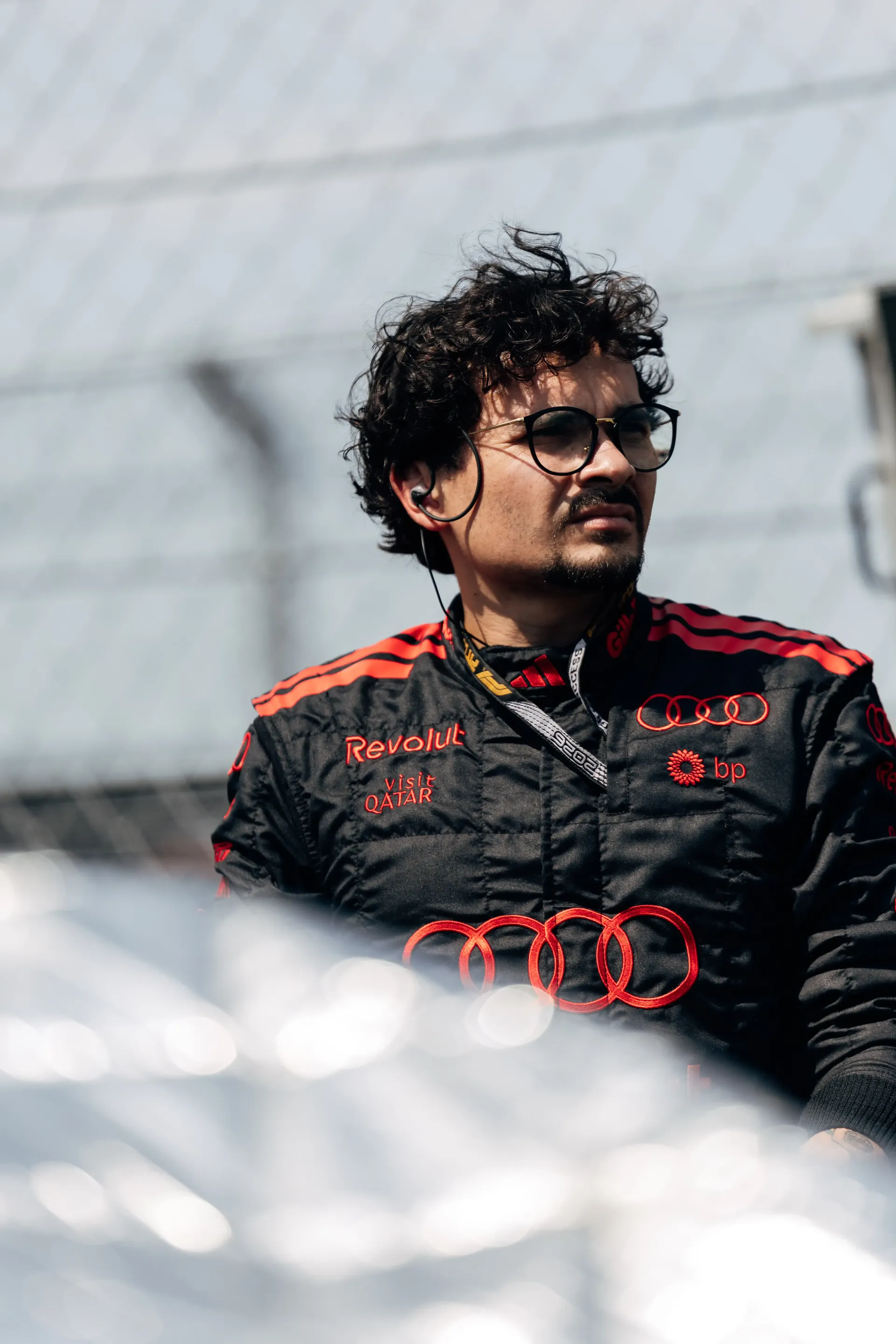 An Audi Revolut F1® Team mechanic stands beside the Audi R26 on the Hungaroring grid before the Hungarian Grand Prix.