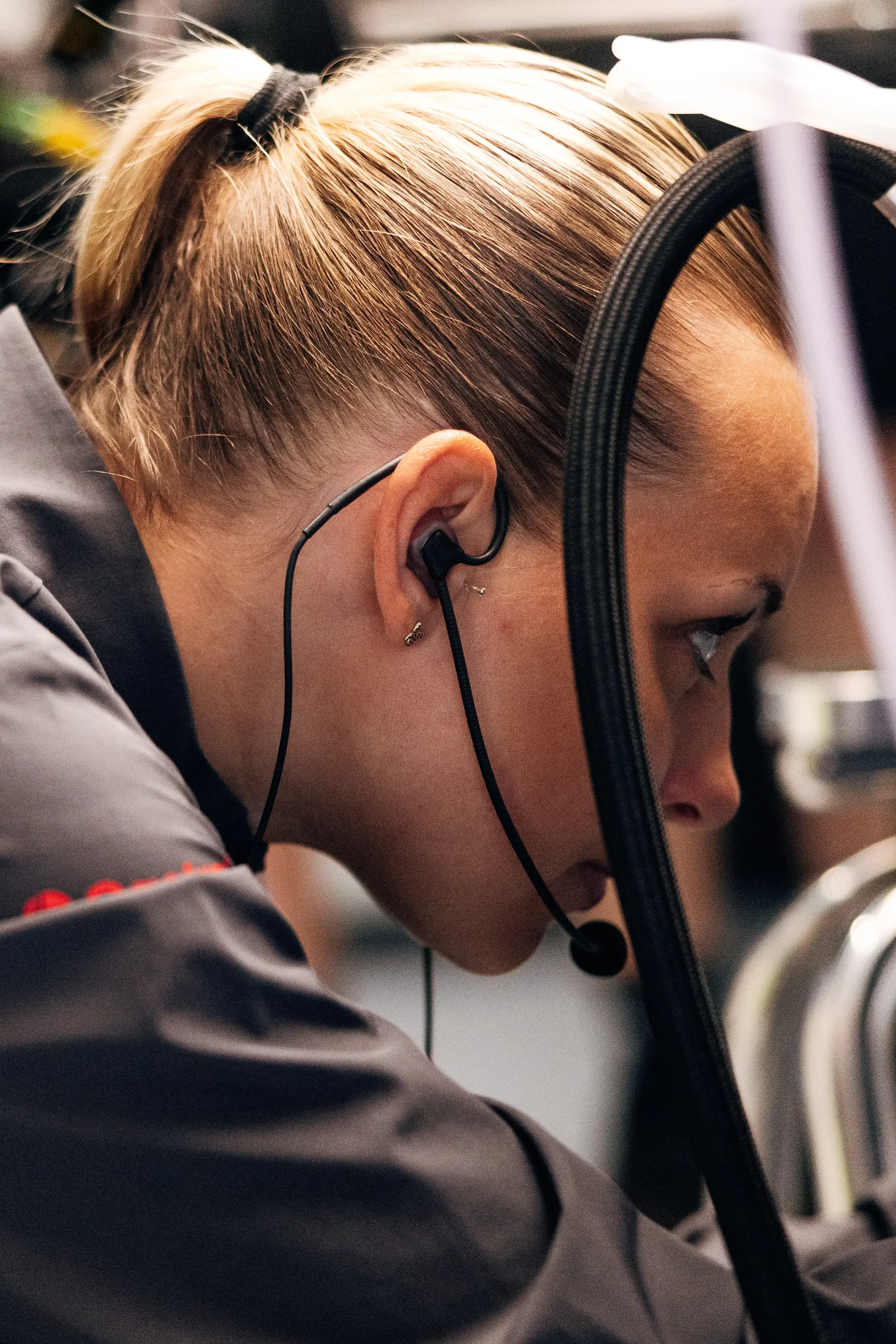 Audi Revolut F1® Team mechanic wearing a headset works on the Audi R26 in the garage ahead of the Hungarian Grand Prix weekend.