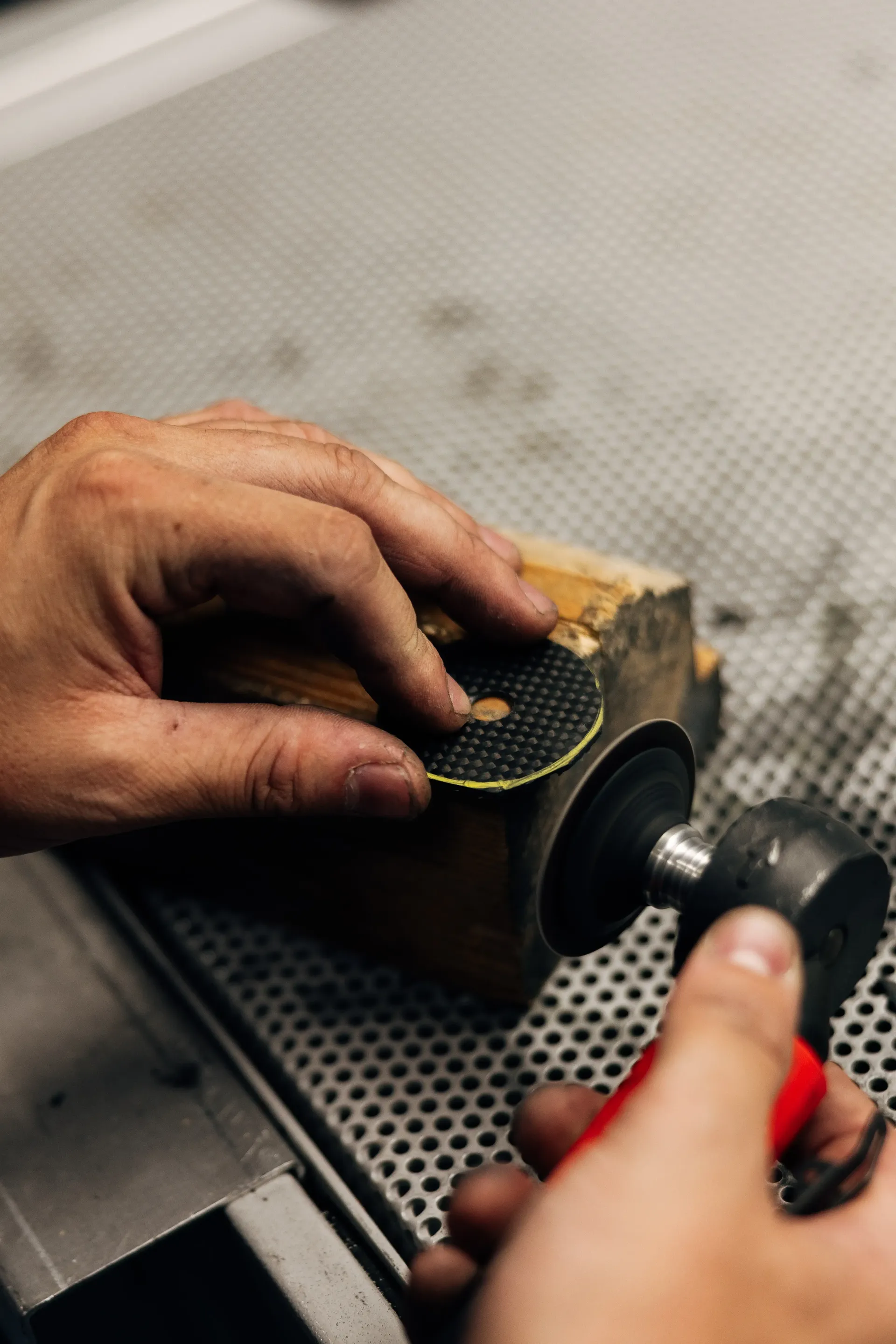 Mechanic prepares a Formula 1® tyre with specialist tools in the Audi Revolut F1® Team garage.