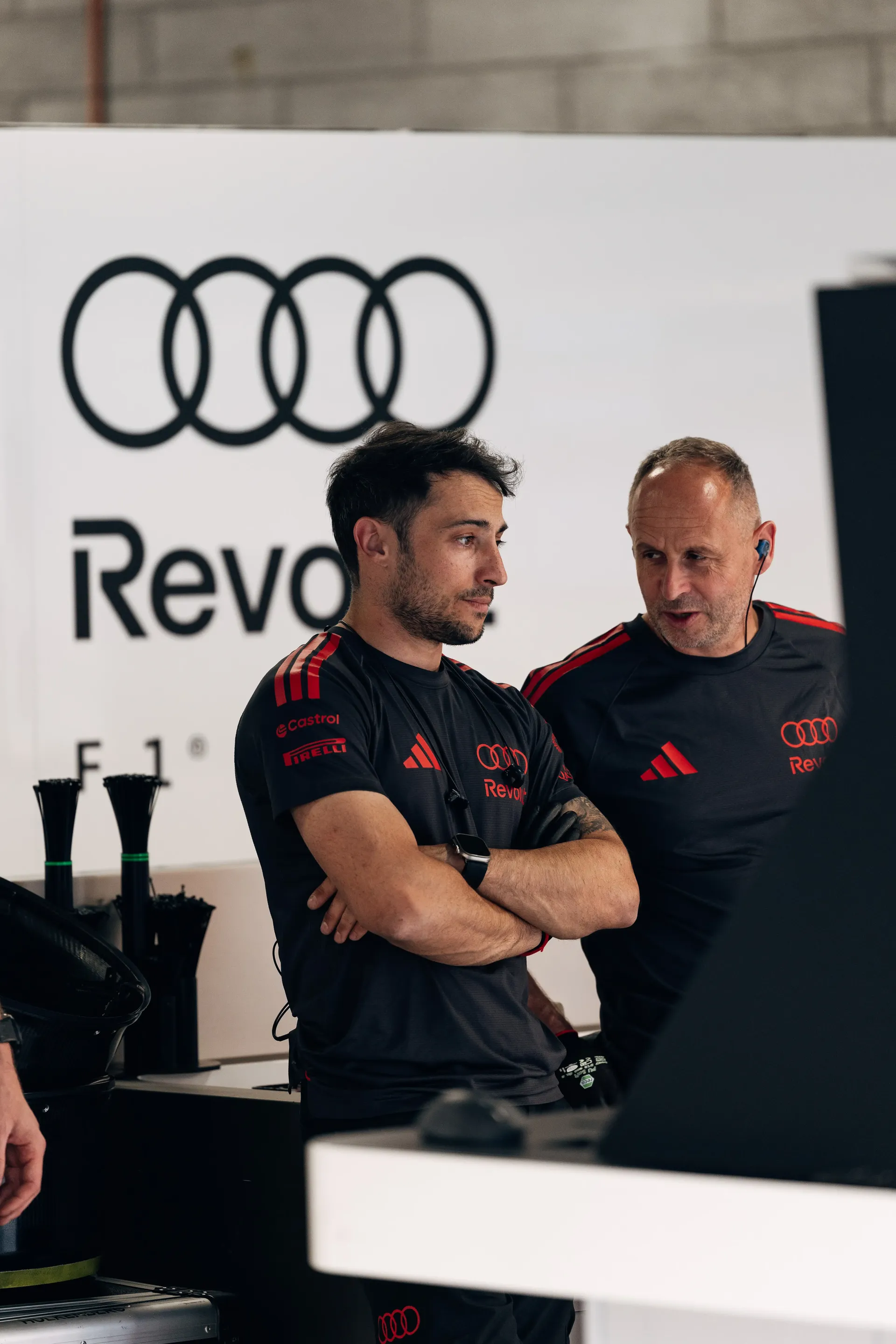 Audi Revolut F1® Team engineers discuss preparations inside the Hungaroring garage.