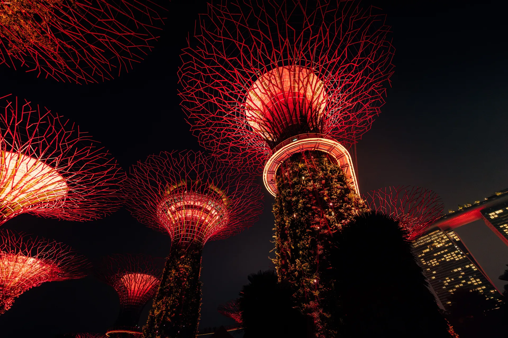 Marina bay at night featuring red neon lights in the sky