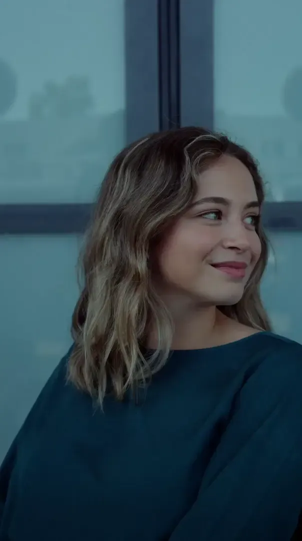 Close up of Sofia Rodrigues, Junior Cost Cap Analyst at the Audi Revolut F1 Team, looking thoughtfully into the distance.