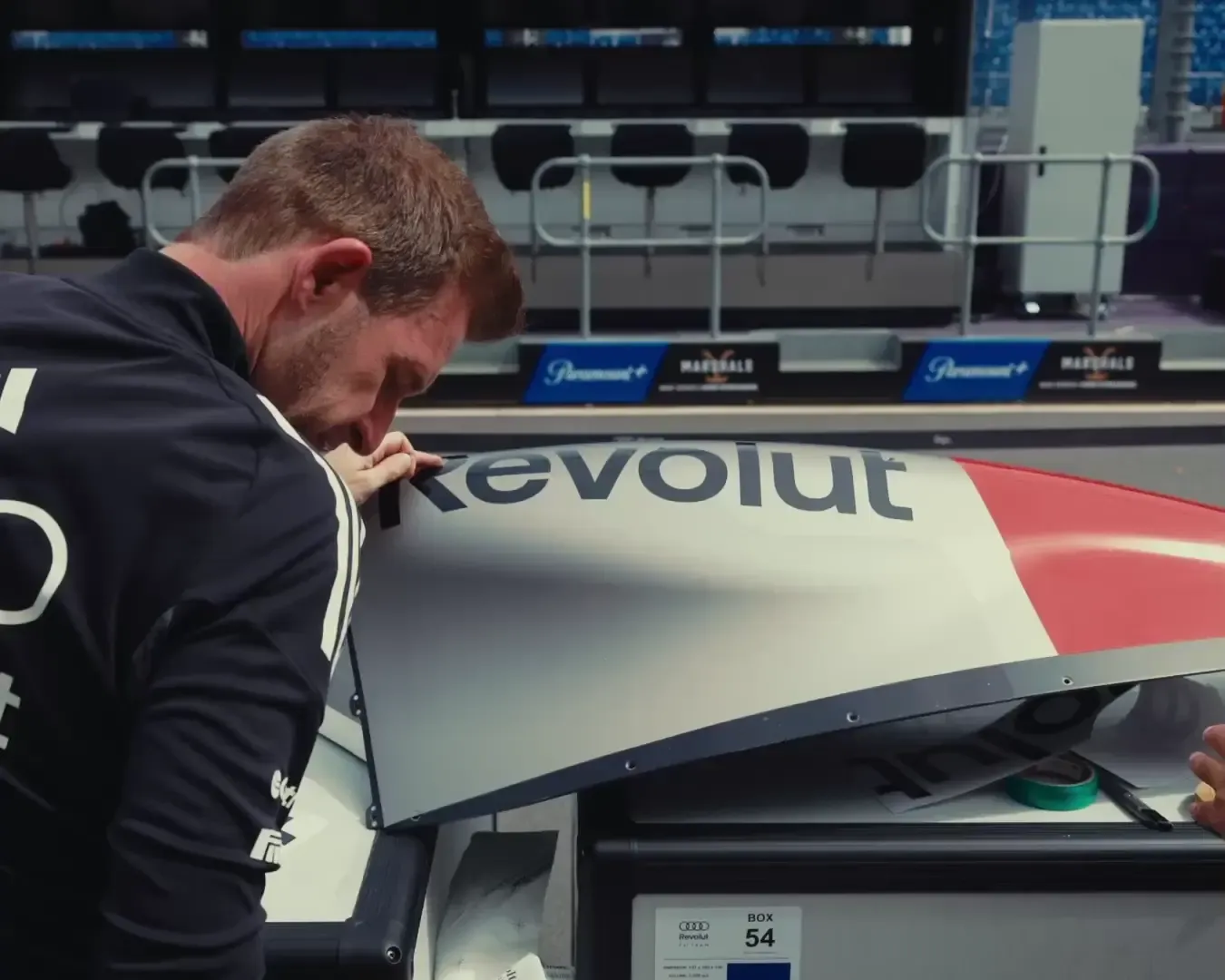 Team member preparing the car with sponsor stickers