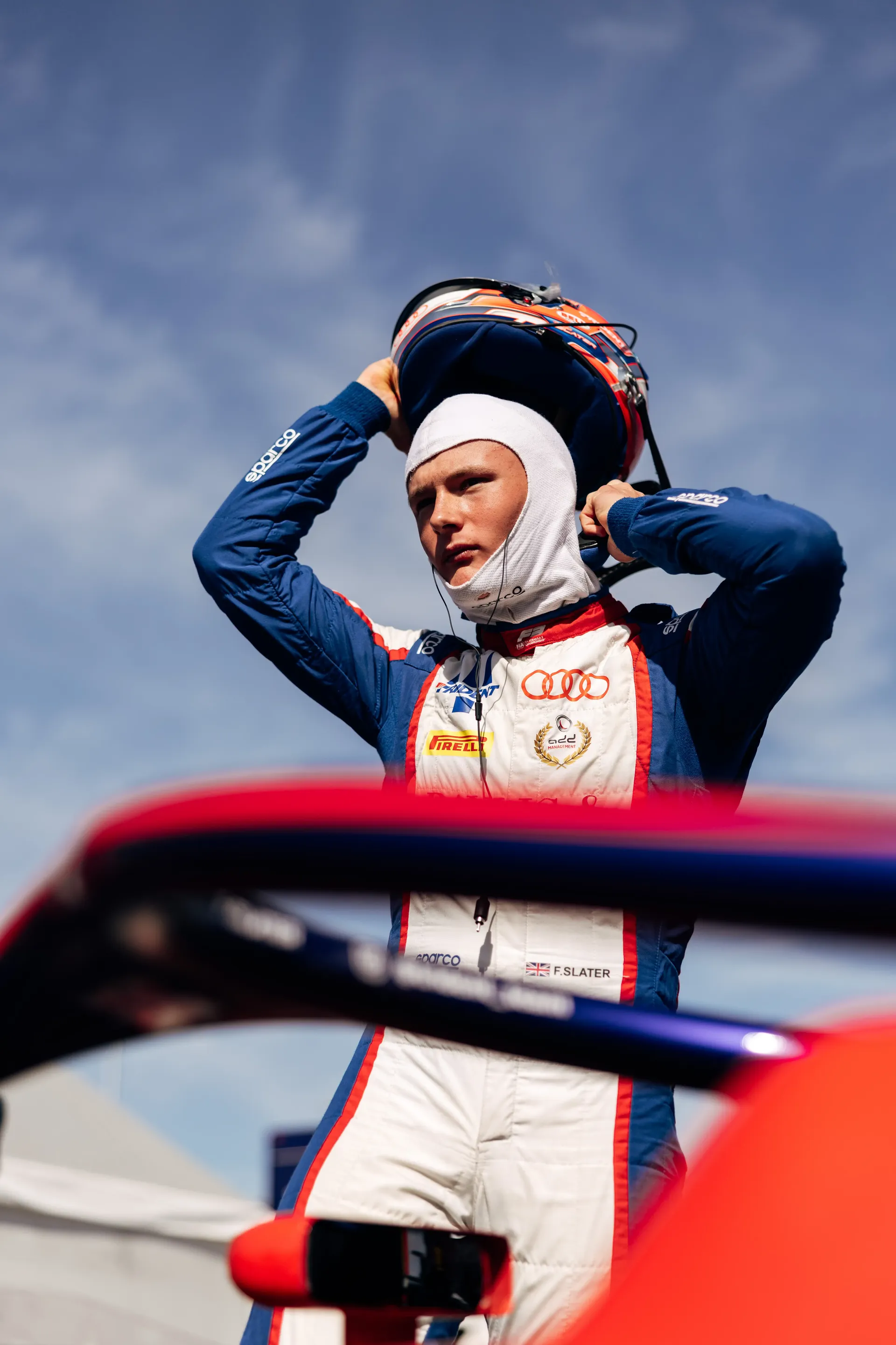 Audi Revolut F1® Team Academy driver Freddie Slater adjusts his helmet before heading out for an FIA Formula 3 session at the Hungaroring.