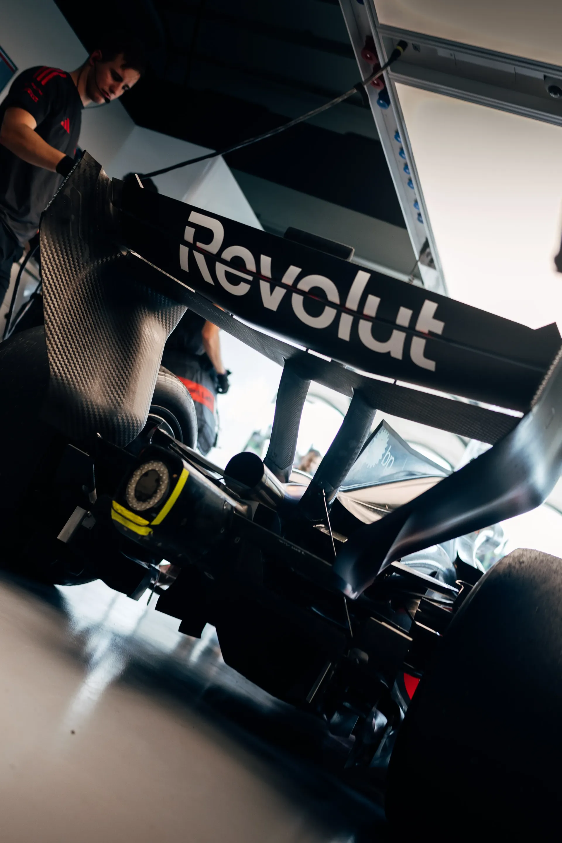 Rear view of the Audi Revolut F1® Team mechanic working on the Audi R26