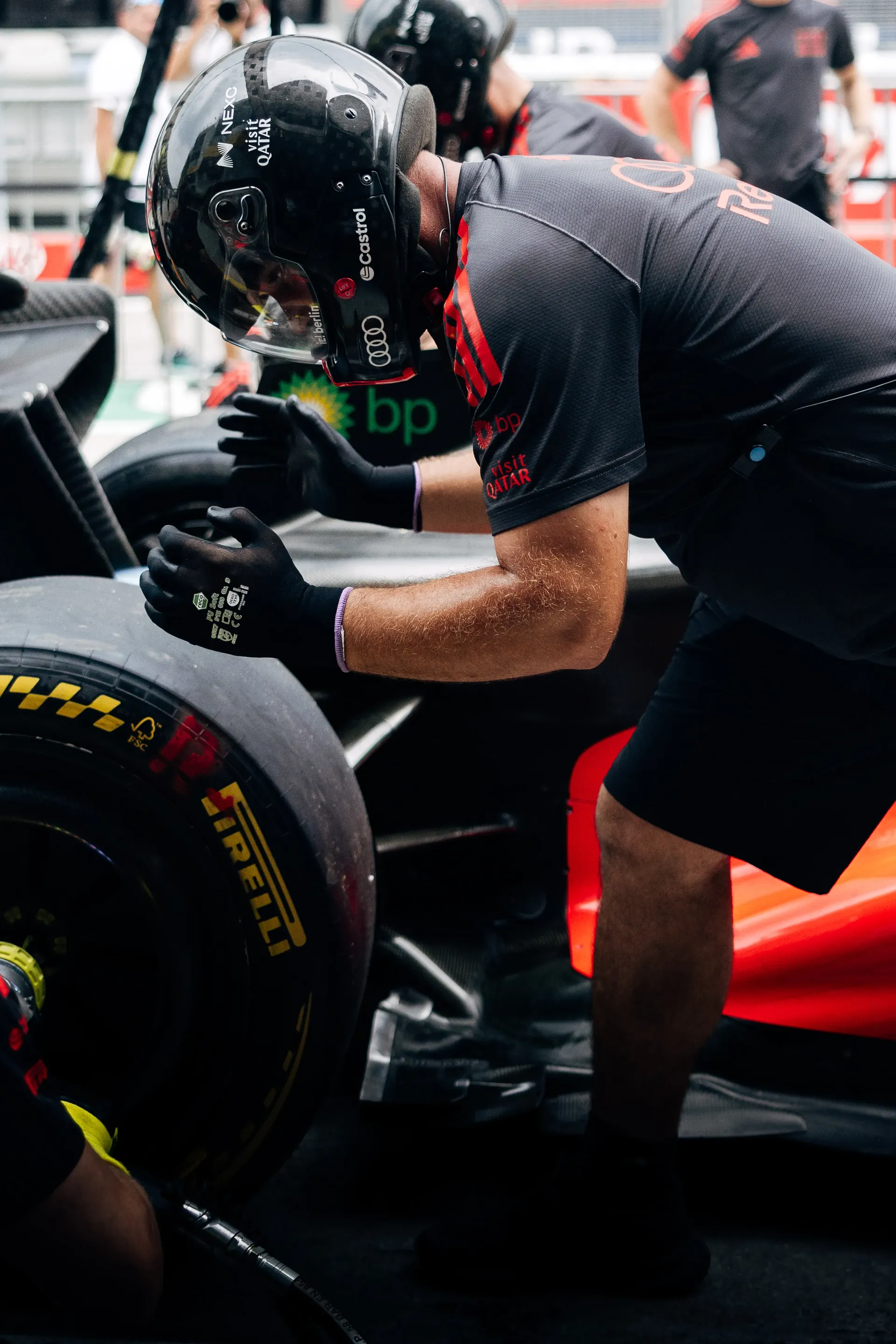 Audi Revolut F1® Team pit stop crew mechanic working on a car wheel