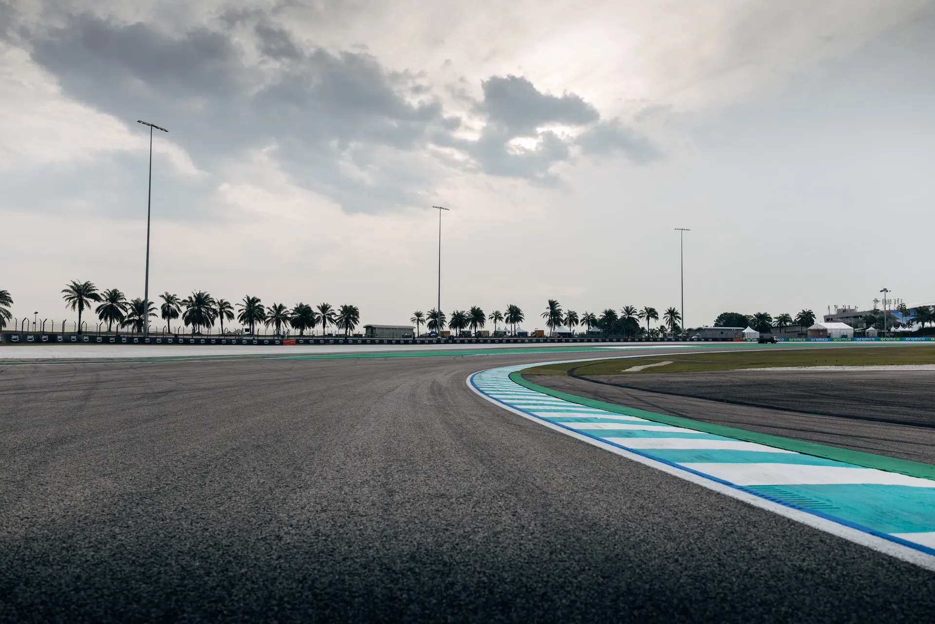 Bahrain International Circuit corner with blue and white kerbs and palm trees