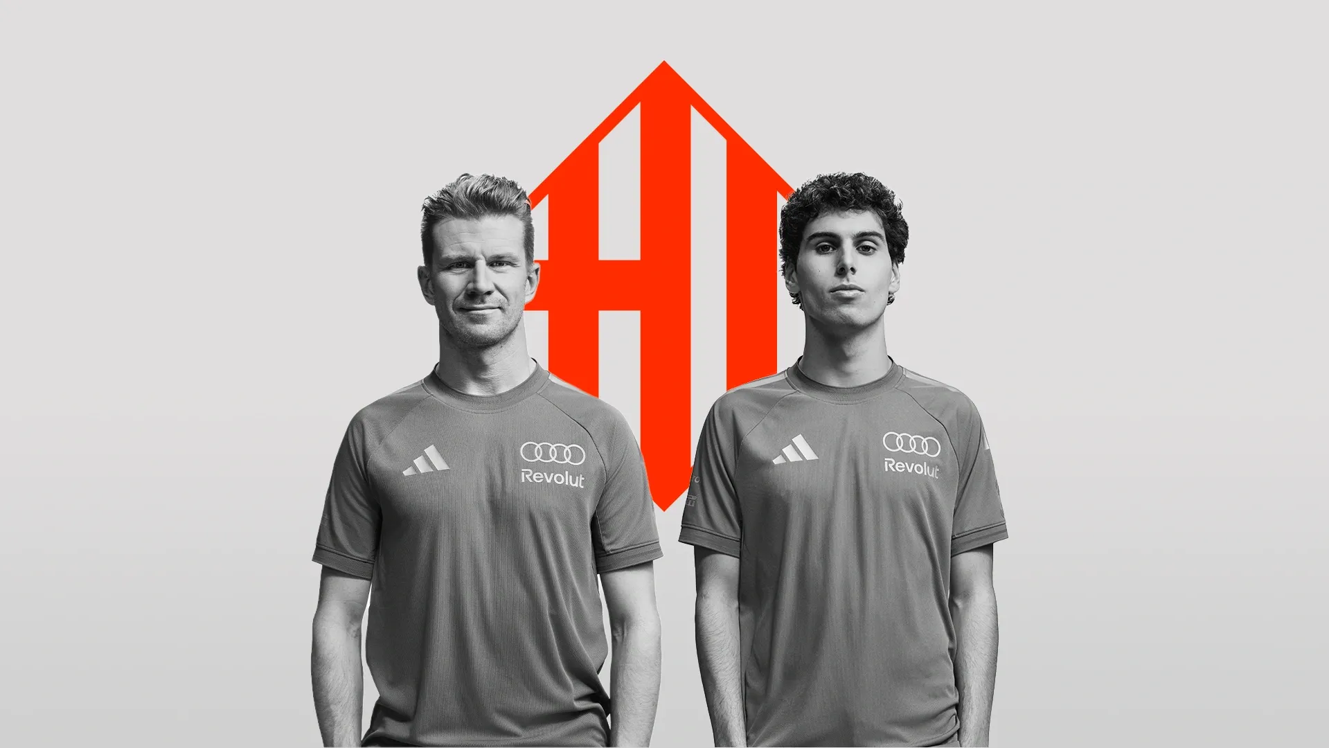Nico Hulkenberg and Gabriel Bortoleto drivers at the Audi Revolut F1® Team standing side by side in relaxed pose in front of the Barcelona Flag