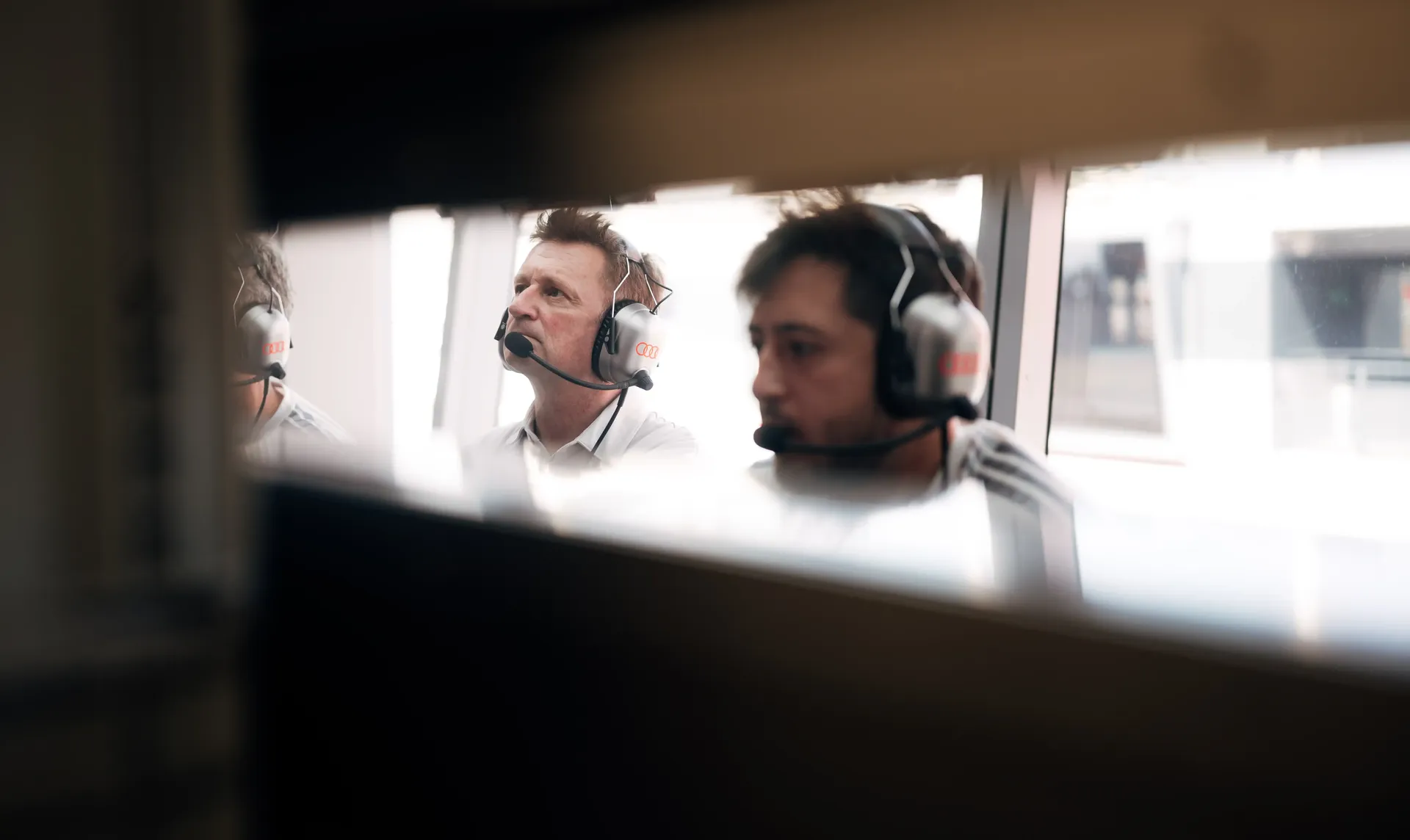 Allan McNish driving director at Audi Revolut F1® Team inside the paddock wearing headphone during fp2 session