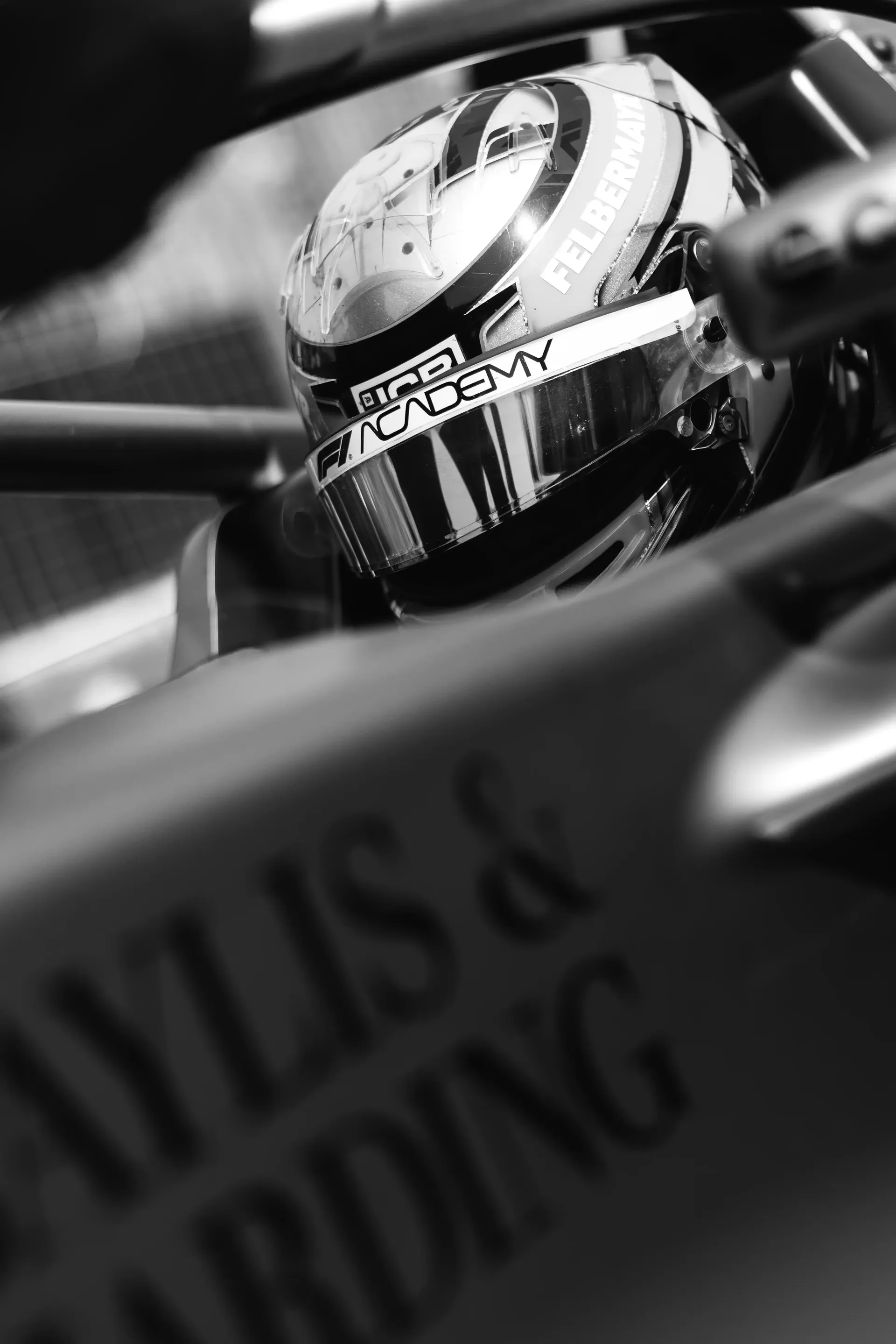 Black and white close up of Emma Felbermayr inside the cockpit of the Audi Revolut F1® Team Academy car at the Canadian Grand Prix 2026