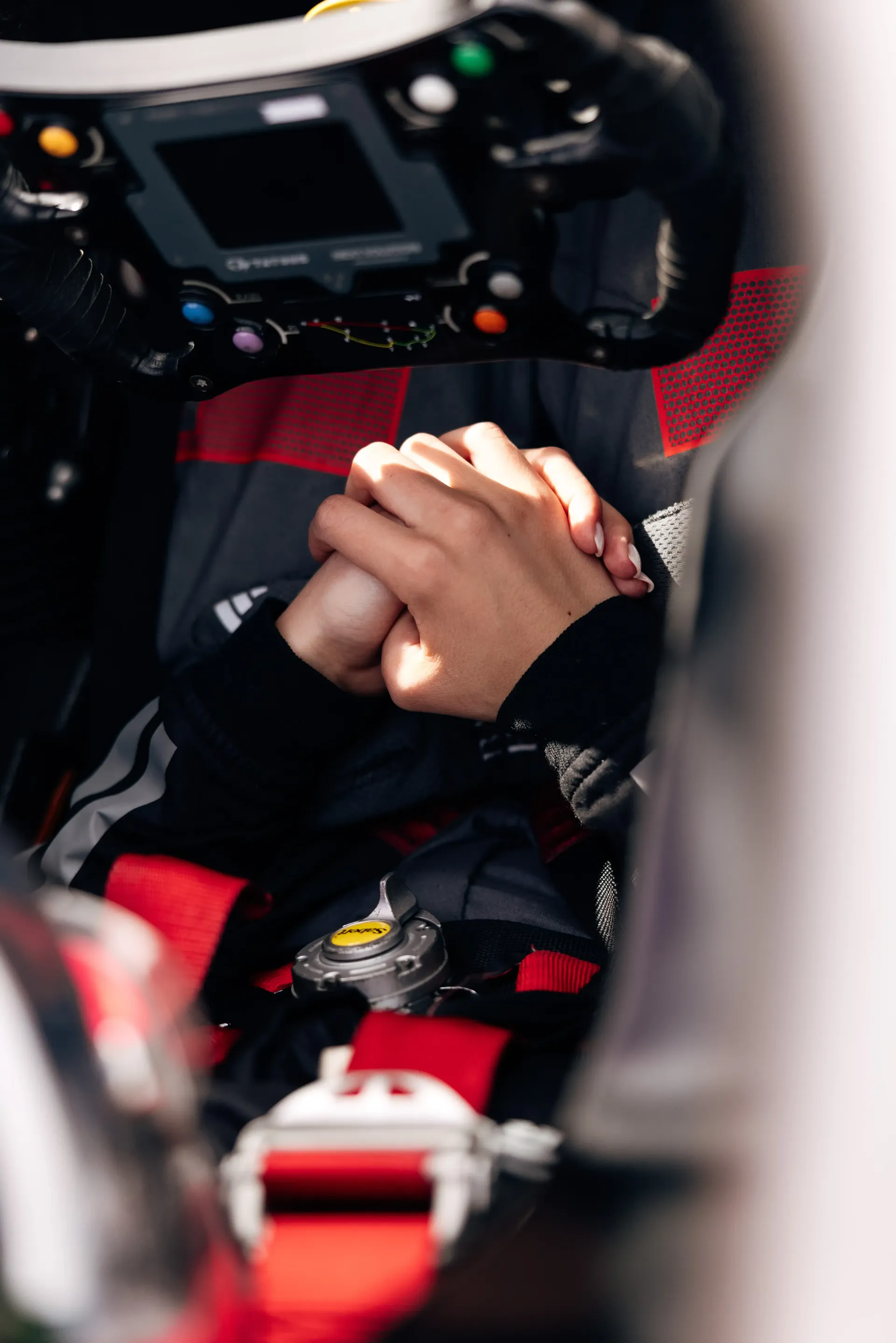 Close up of Emma Felbermayr holding hands with crew member inside the cockpit of the Audi Revolut F1® Team Academy car at the Canadian Grand Prix 2026