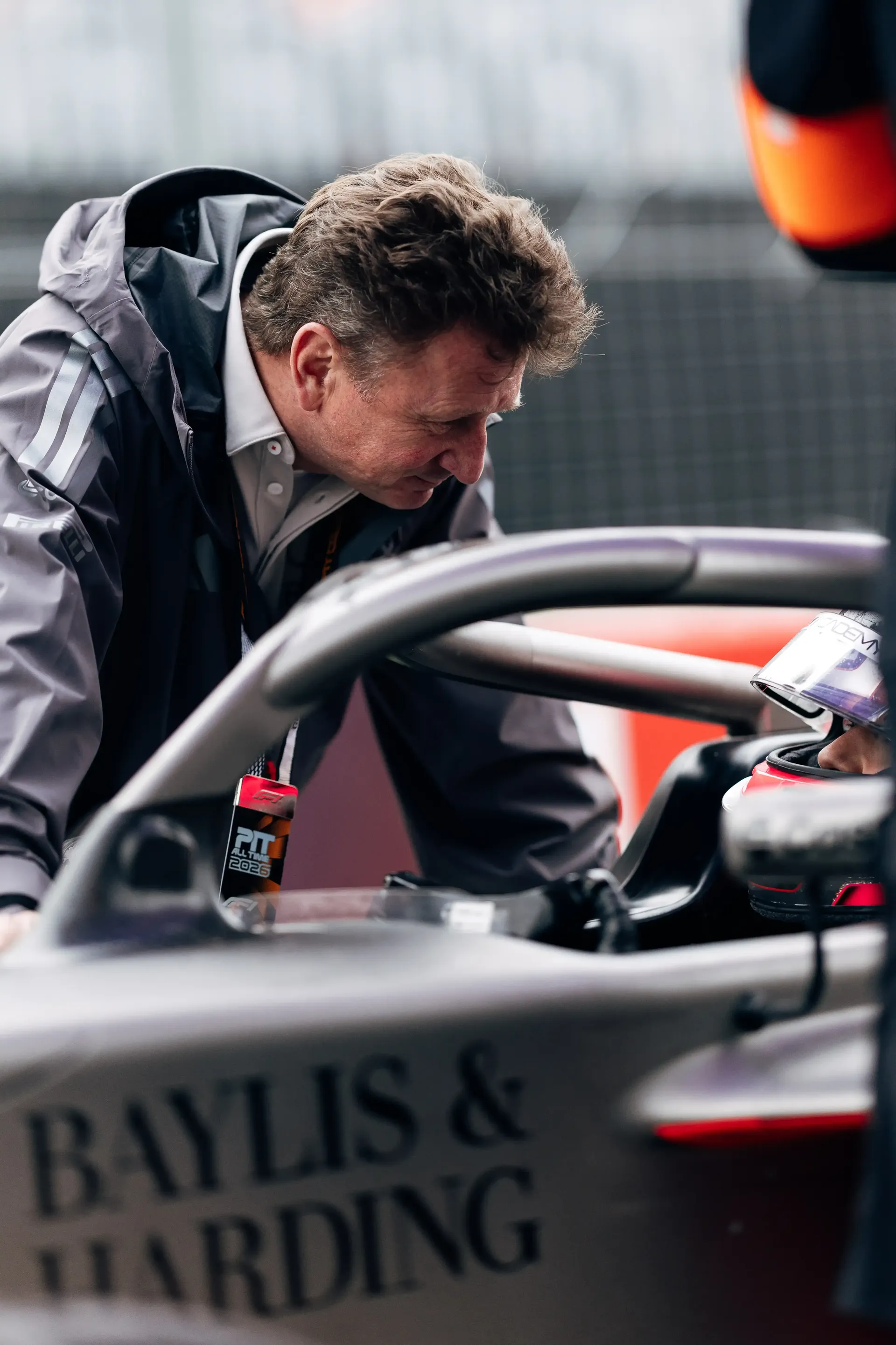 Emma Felbermayr driver at the Audi Revolut F1® Team Academy inside the cockpit listening to Allan McNish standing beside her F2 racing car at the Canada Grand Prix 2026 on racing day