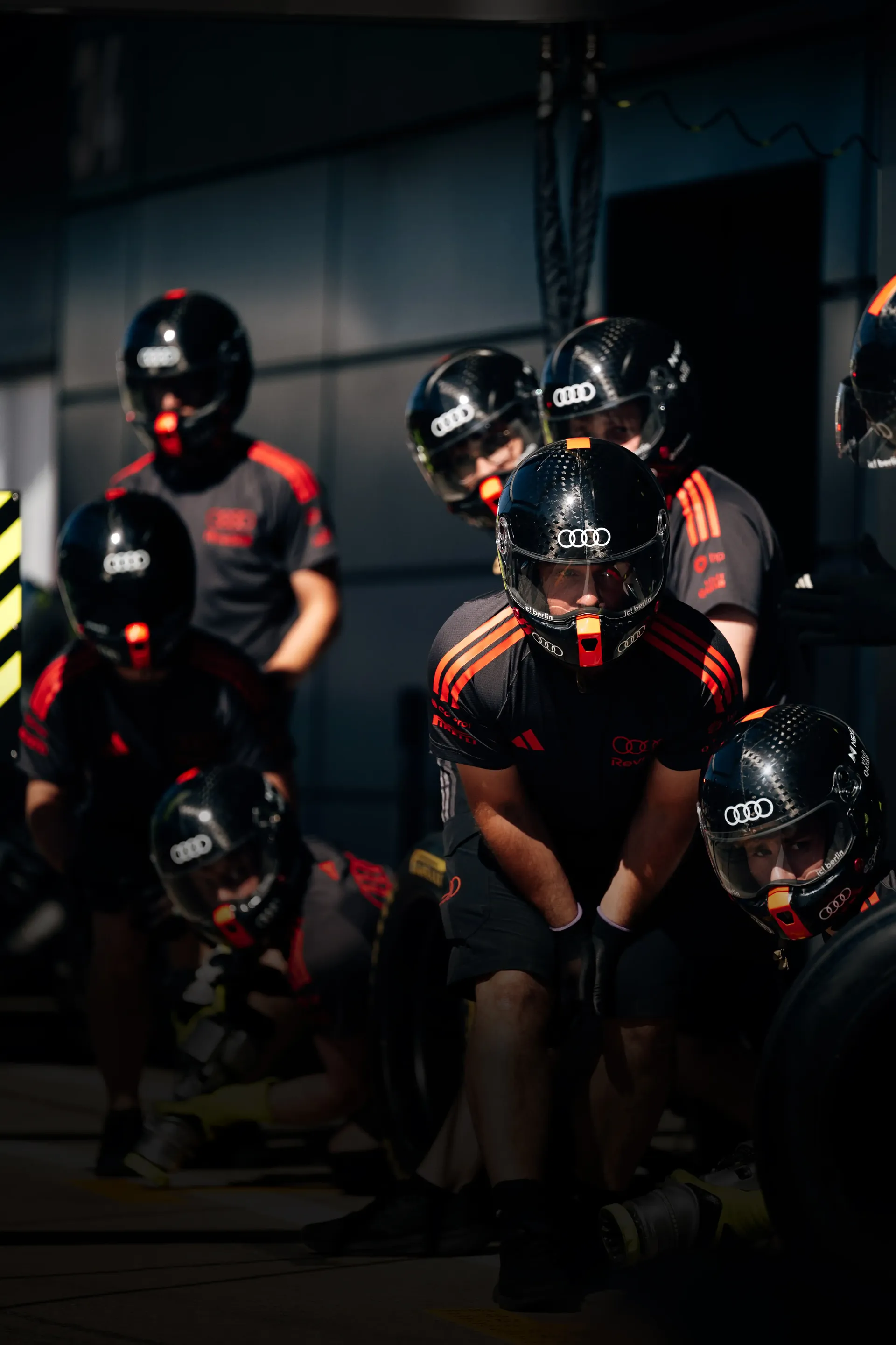 Close up of the Audi Revolut F1® Team pitstop crew in action, waiting for the Audi R26