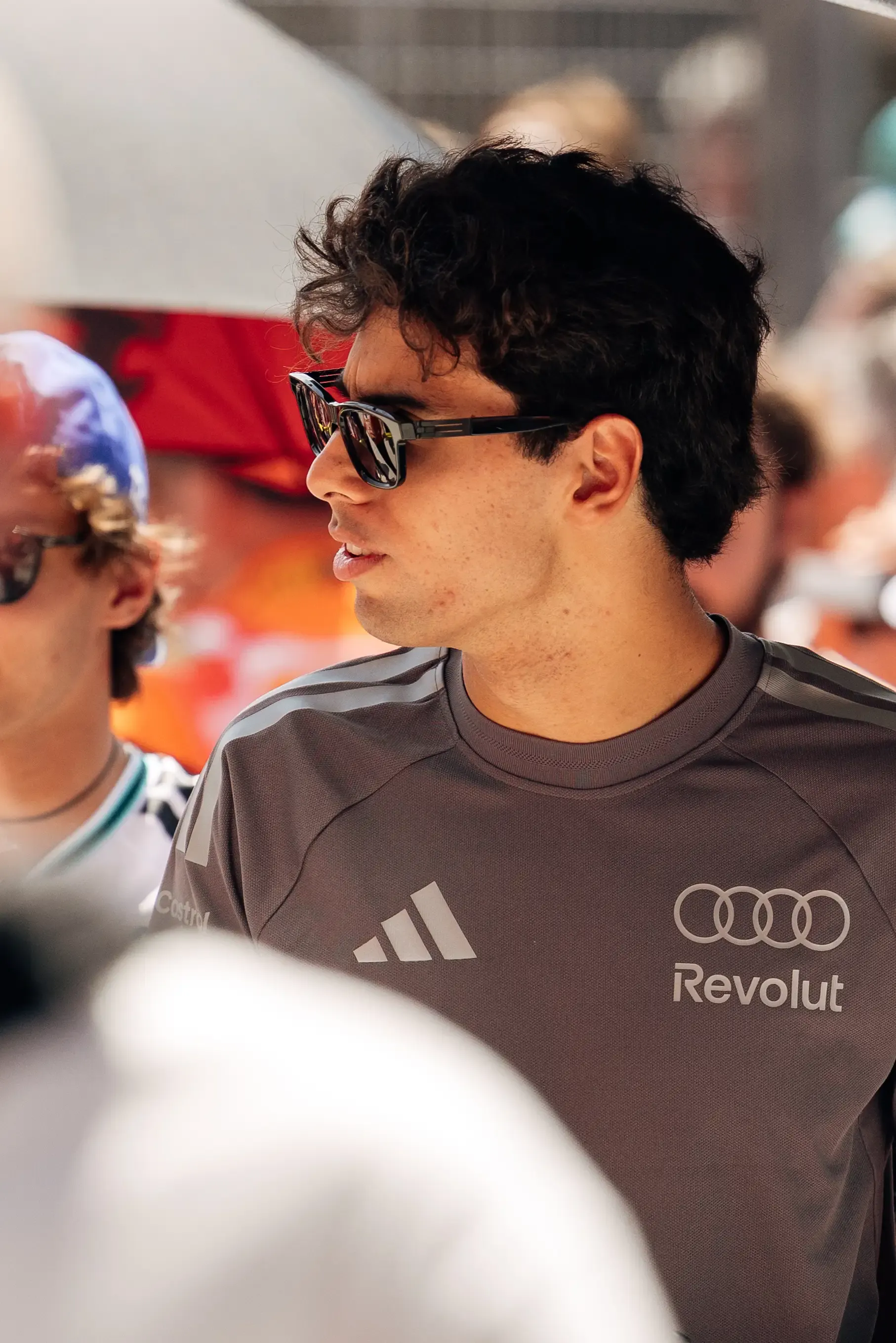 Gabriel Bortoleto looks across the crowd during the drivers' parade at the Hungarian Grand Prix, wearing an Audi Revolut F1® Team shirt.