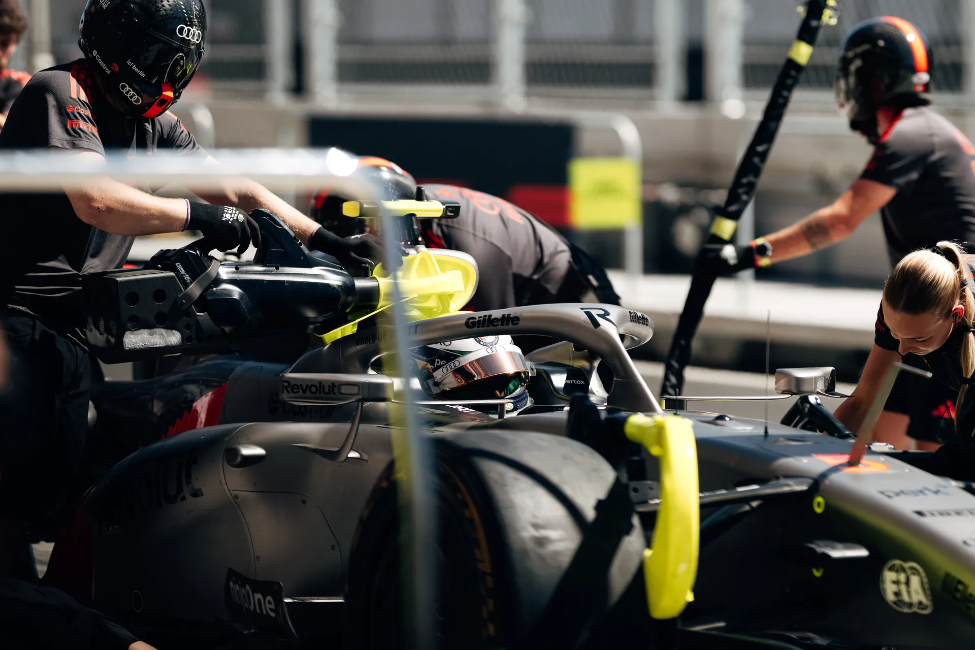 Audi Revolut F1® Team pit crew working on the car with Nico Hulkenberg in the cockpit in the Madrid pit lane