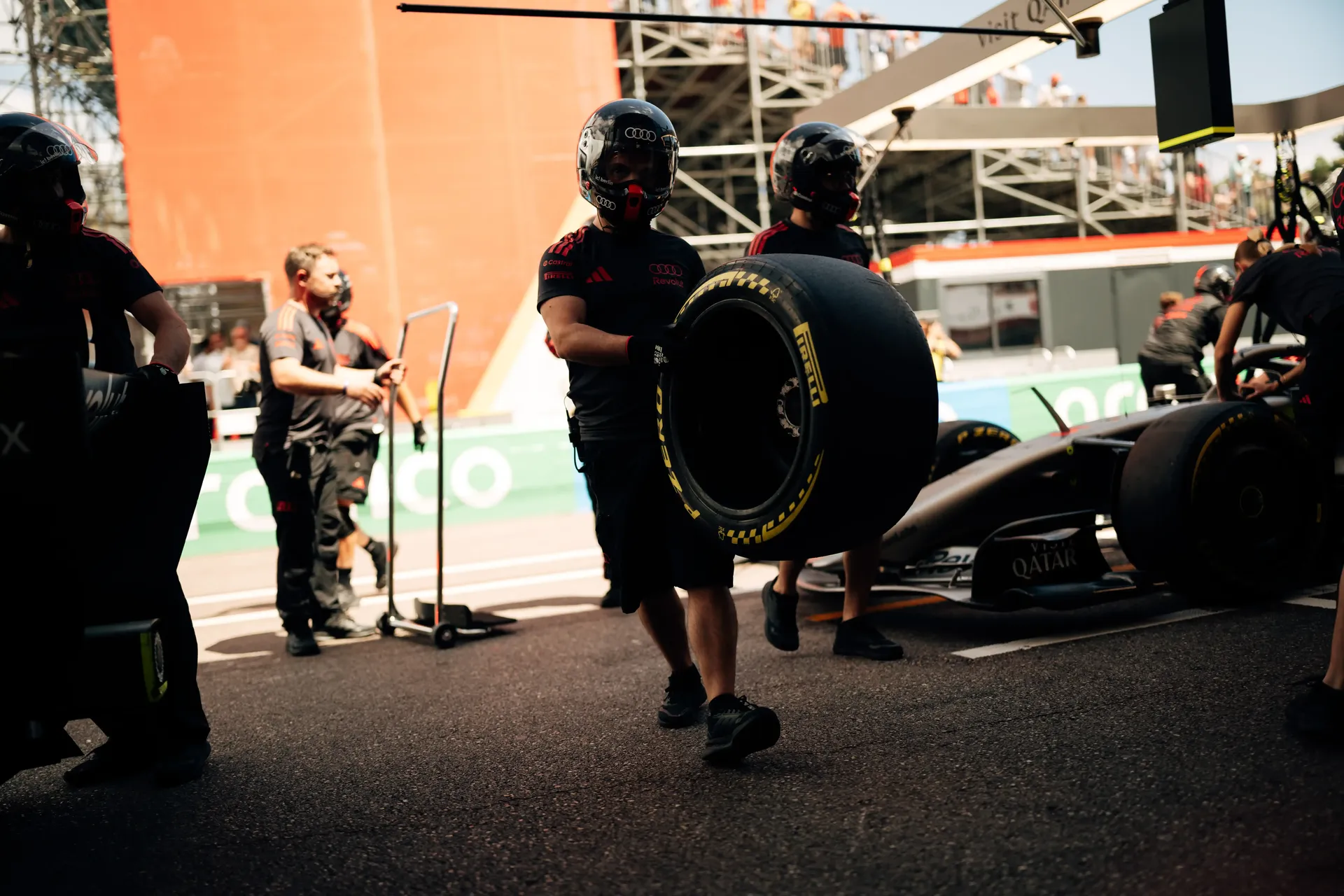 Audi Revolut F1® Team crew mechanic move equipment and tires beside the F1® car in the Monaco pit lane.