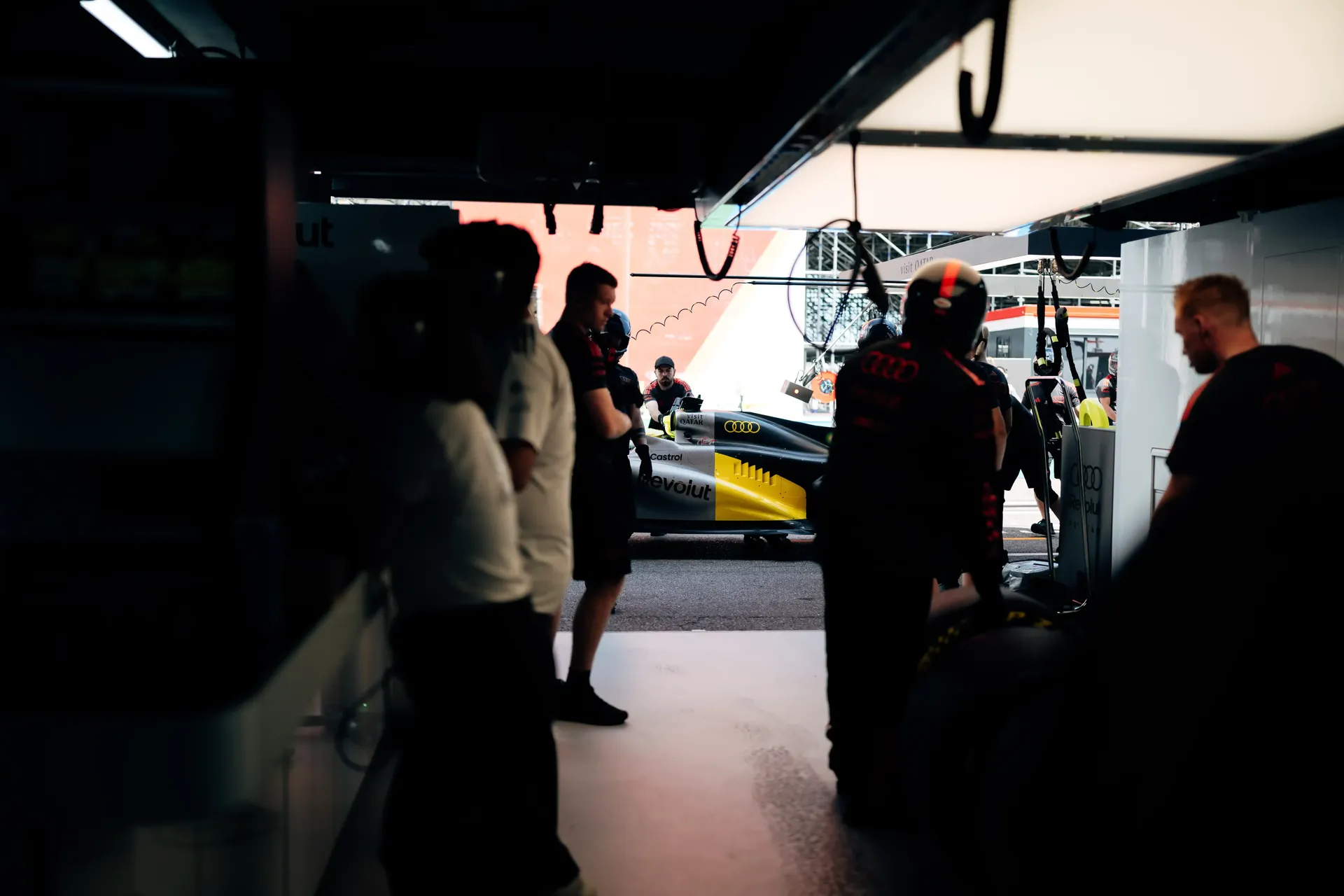 Audi Revolut F1® Team personnel work around the garage entrance as the F1® car prepares for Monaco FP1.