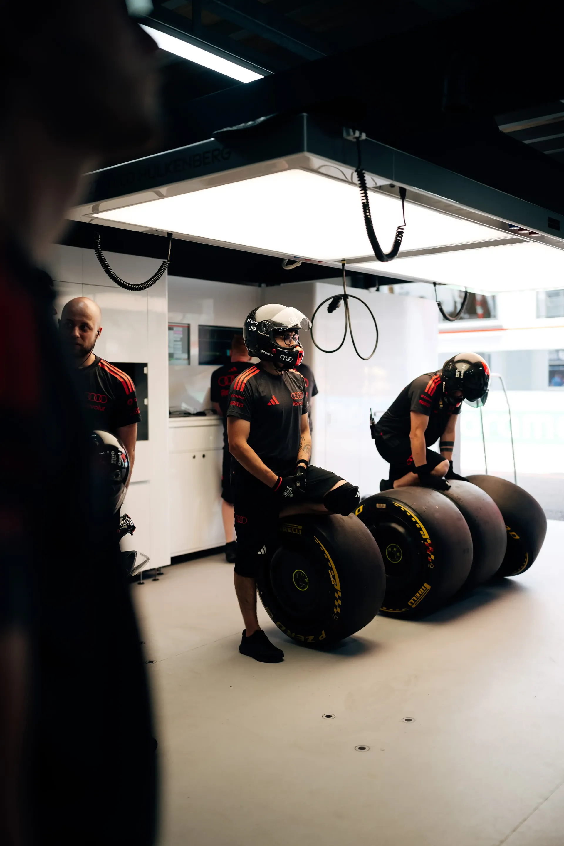 Audi Revolut F1® Team mechanics prepare tire sets inside the Monaco garage during FP1.