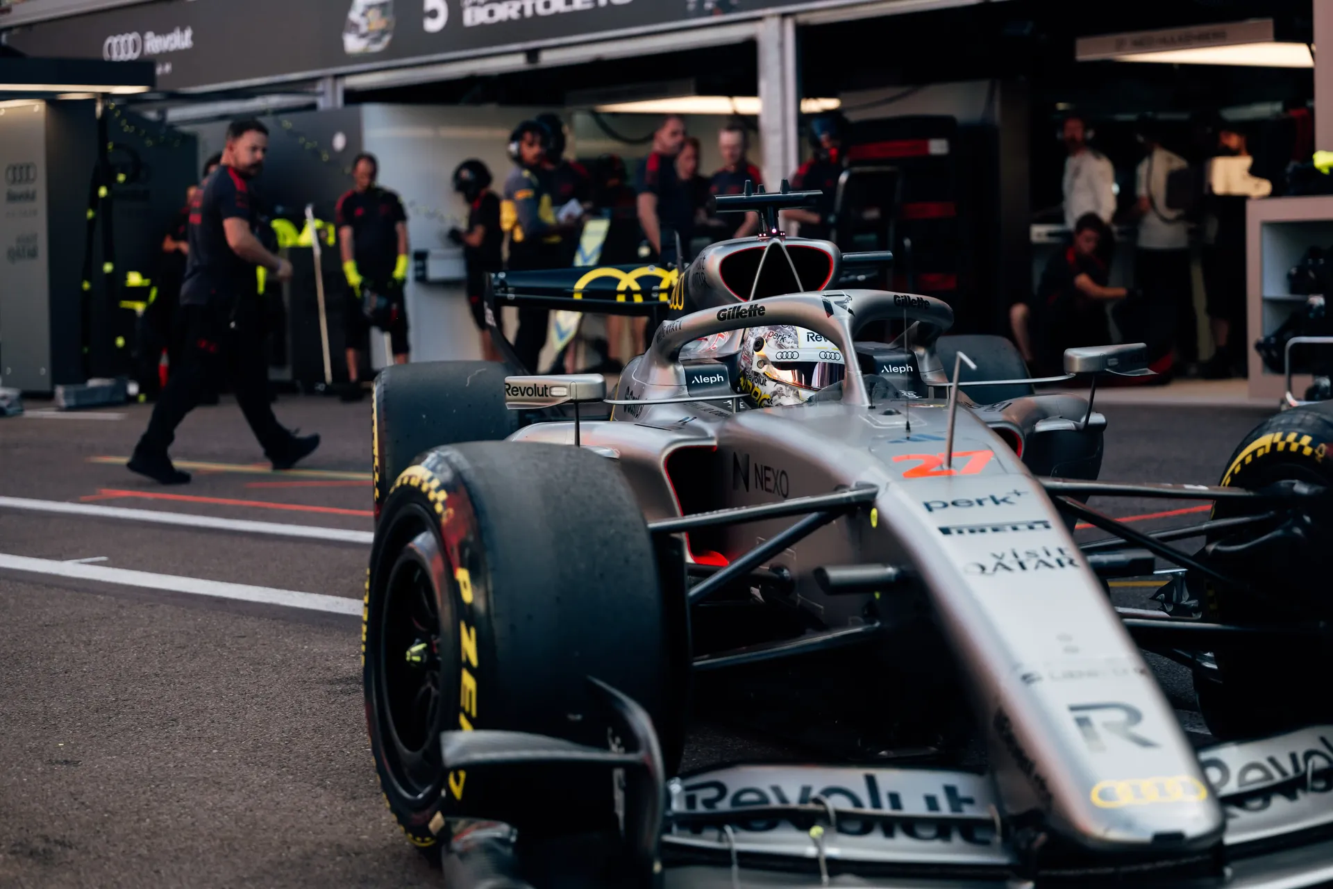 Audi Revolut F1® Team Formula 1 car being pushed through the pit lane by mechanics.