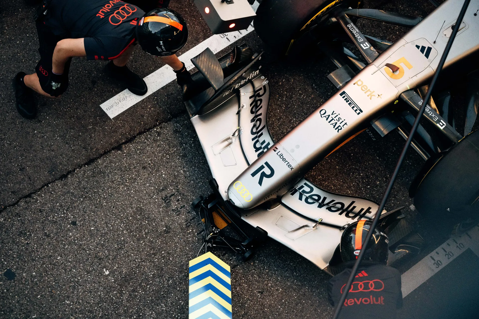 Top-down view of the Audi Revolut F1® Team car's nose and front wing in the pit lane.