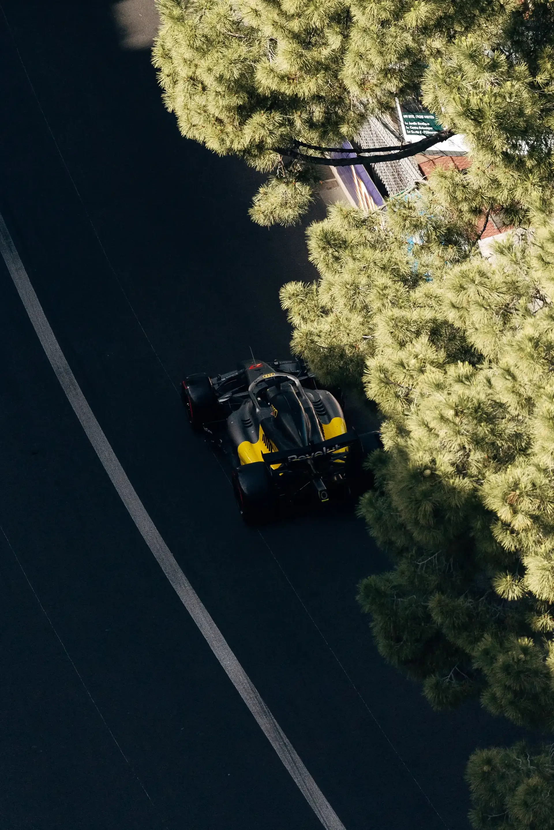 Audi Revolut F1® Team race car R26 drives along a tree-lined section of the Monaco street circuit during qualifying.