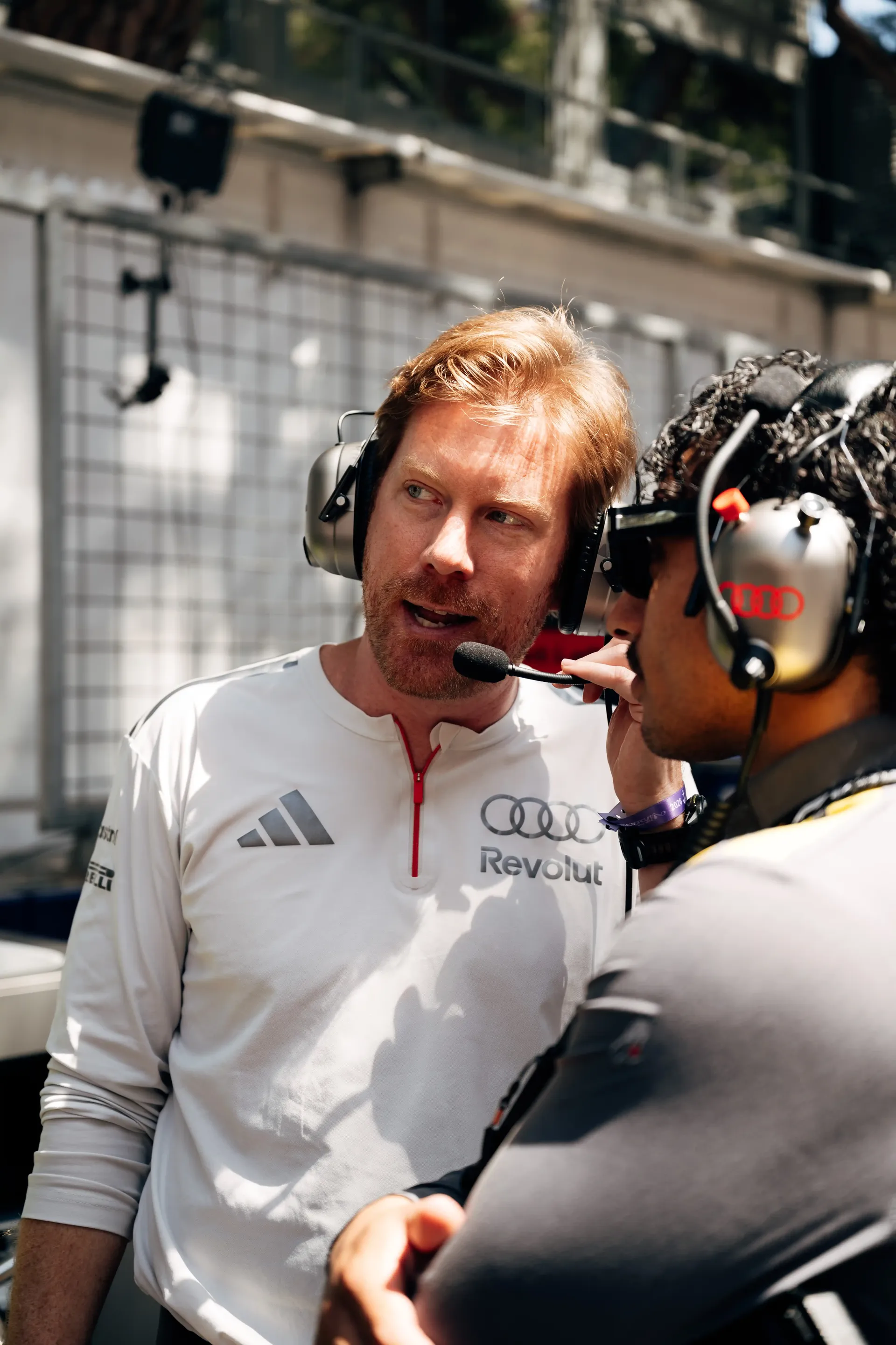 Audi Revolut F1® Team engineer speaks with a crew member during pre-race preparations in Monaco.