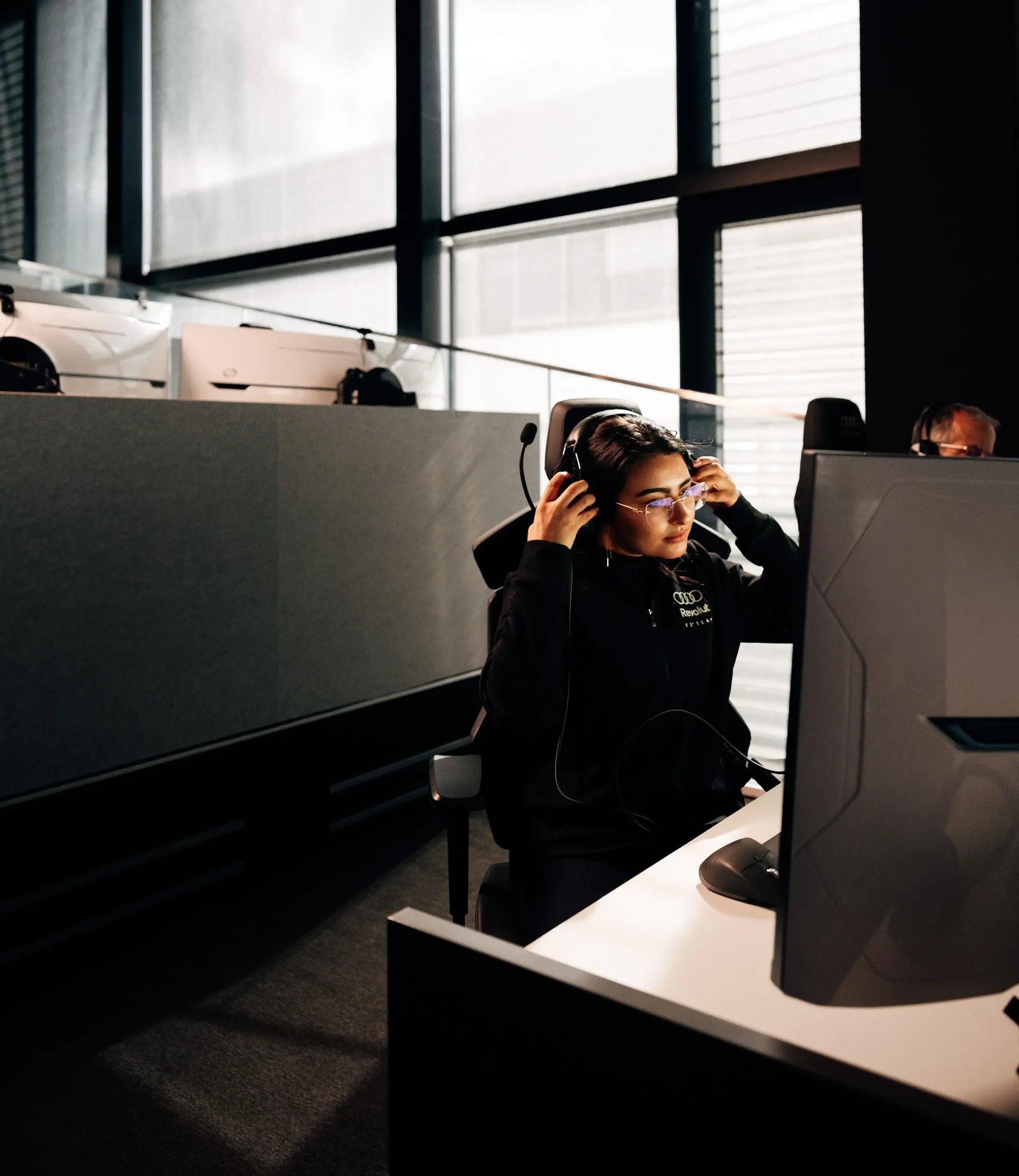 Khawla, IT Infrastructure Engineer at Audi Revolut F1® Team, working in the Mission Control office in Neuburg, monitoring critical IT systems supporting Formula 1® race operations.