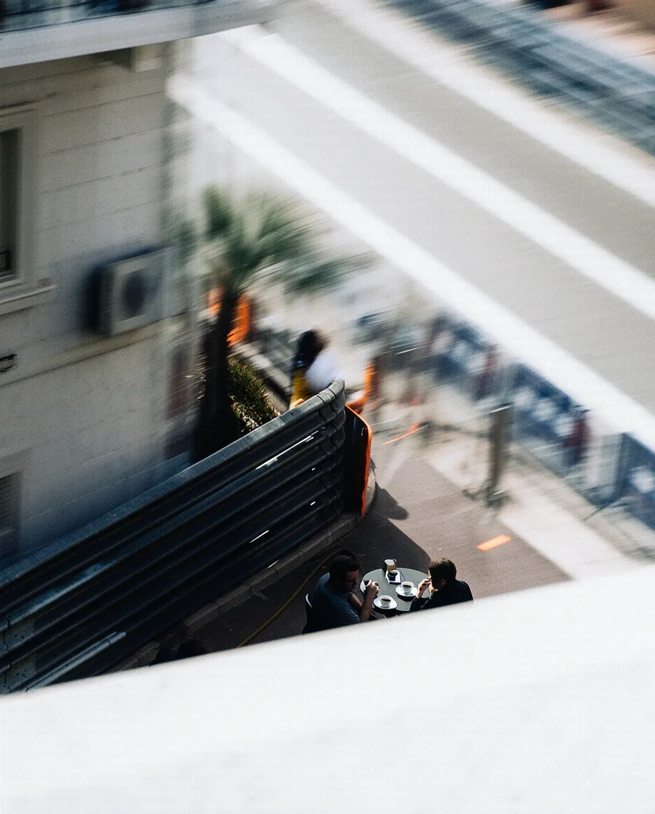 Motion-blurred city scene viewed from above, capturing Monaco’s urban energy.