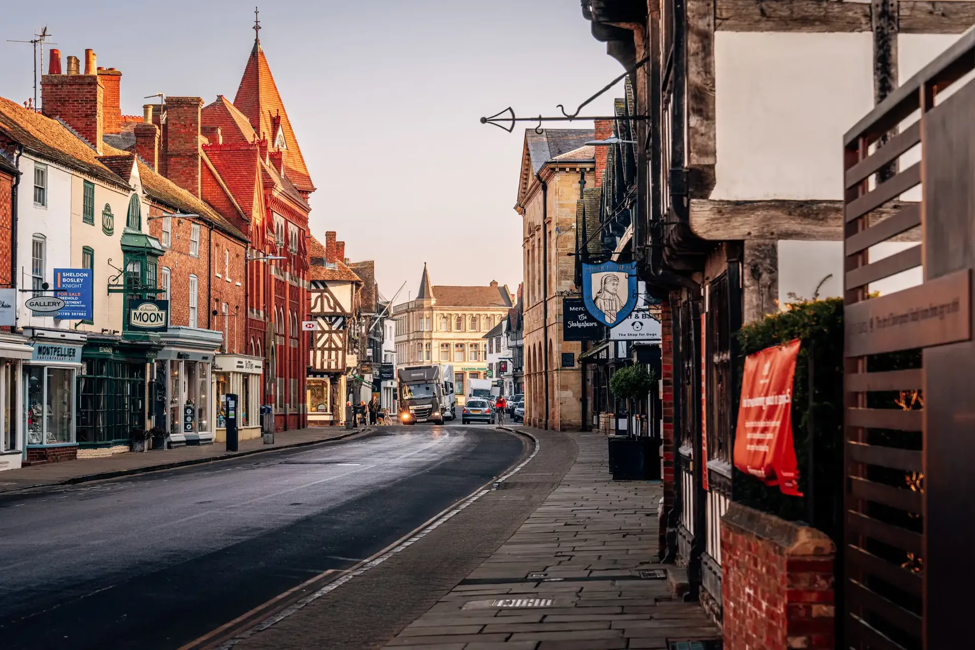 Quiet village high street with traditional buildings near Silverstone.